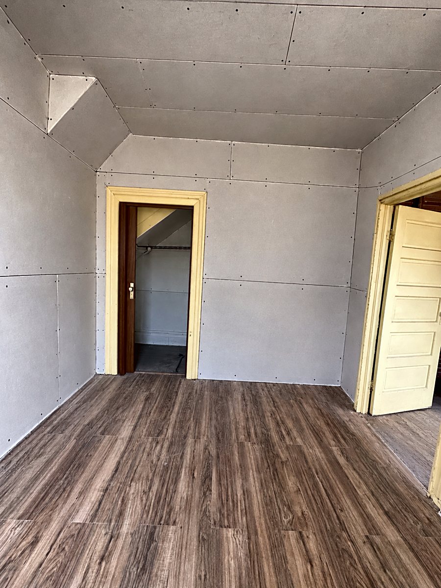 Room 5: installed drywall panels with taped seams