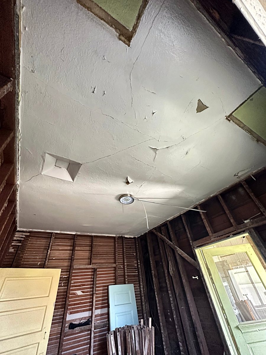 Room 1: exposed wall framing during demolition