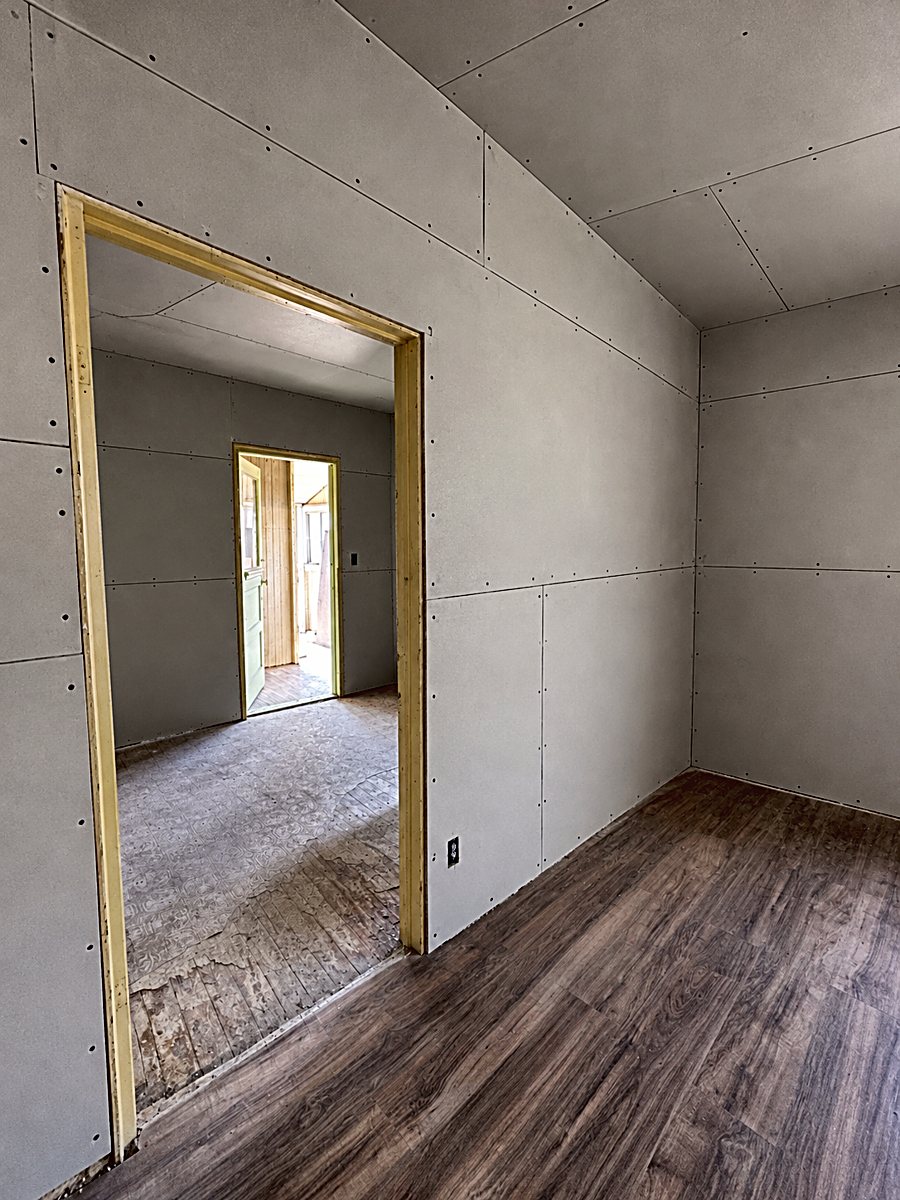 Room 7: installed drywall panels with taped seams