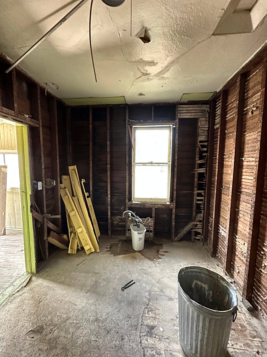 Room 3: exposed wall framing during demolition
