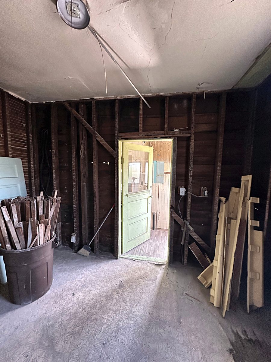 Room 2: exposed wall framing during demolition