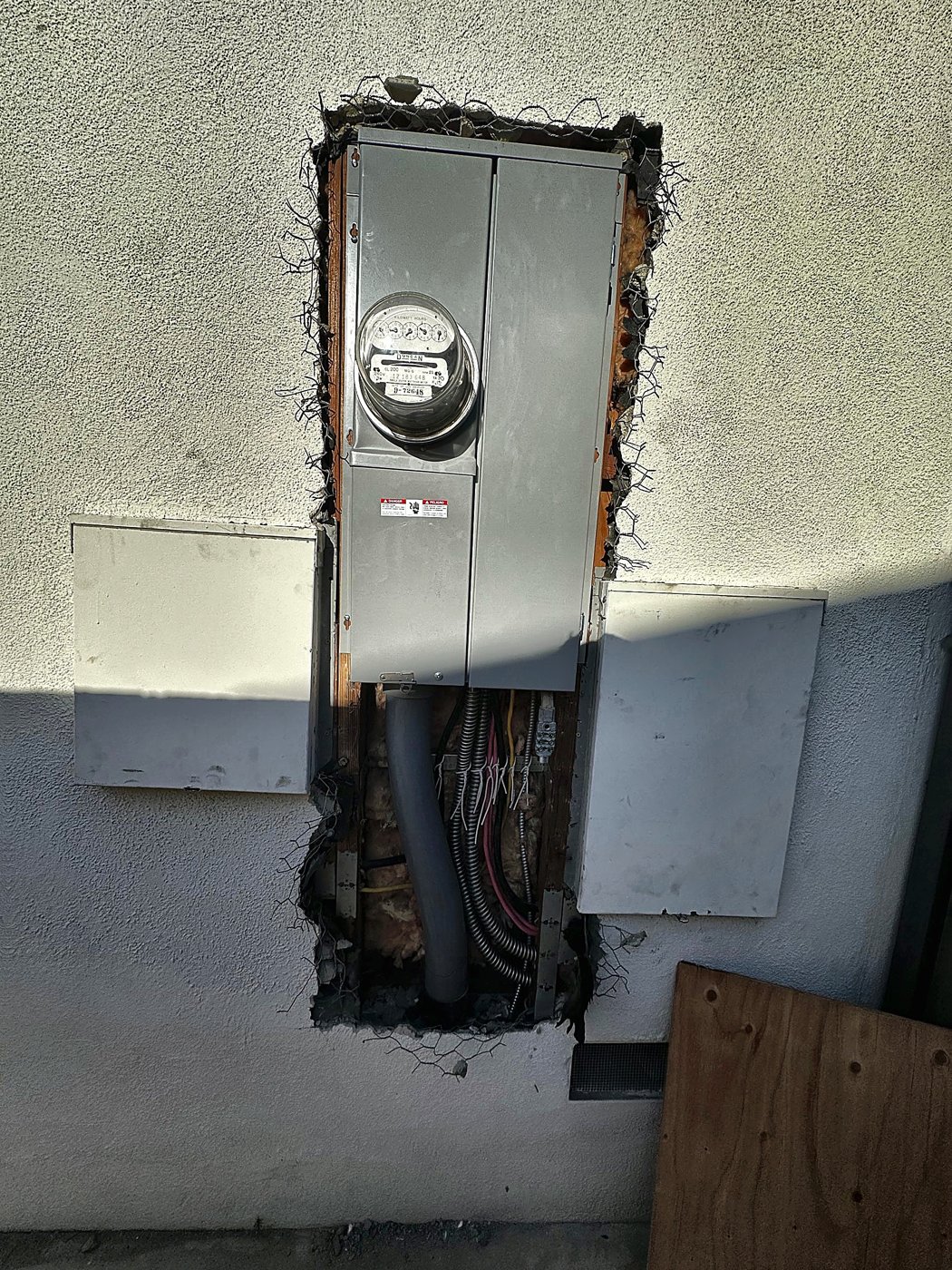 Wall opened up around an electric meter